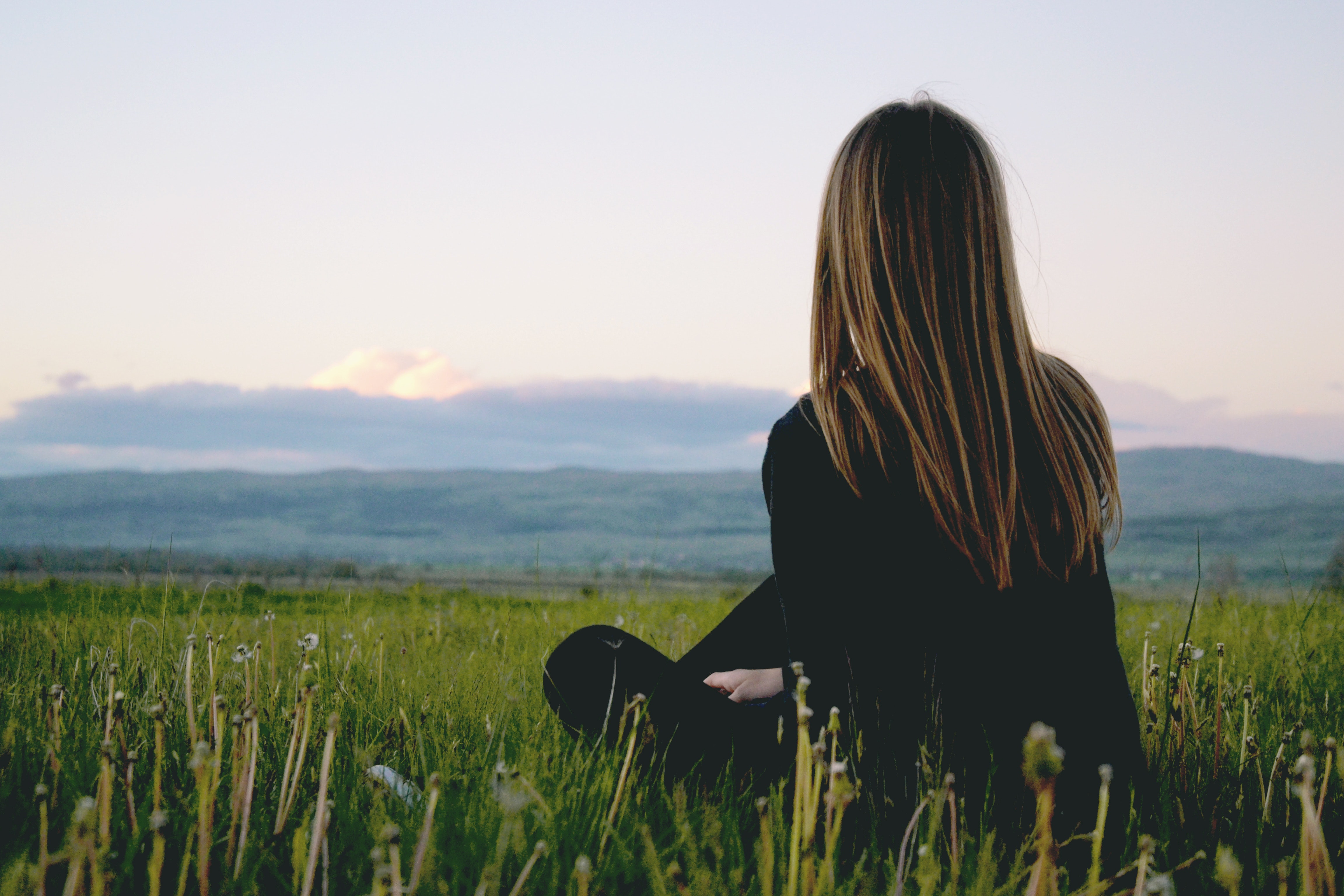 girl on grass looking in the distance