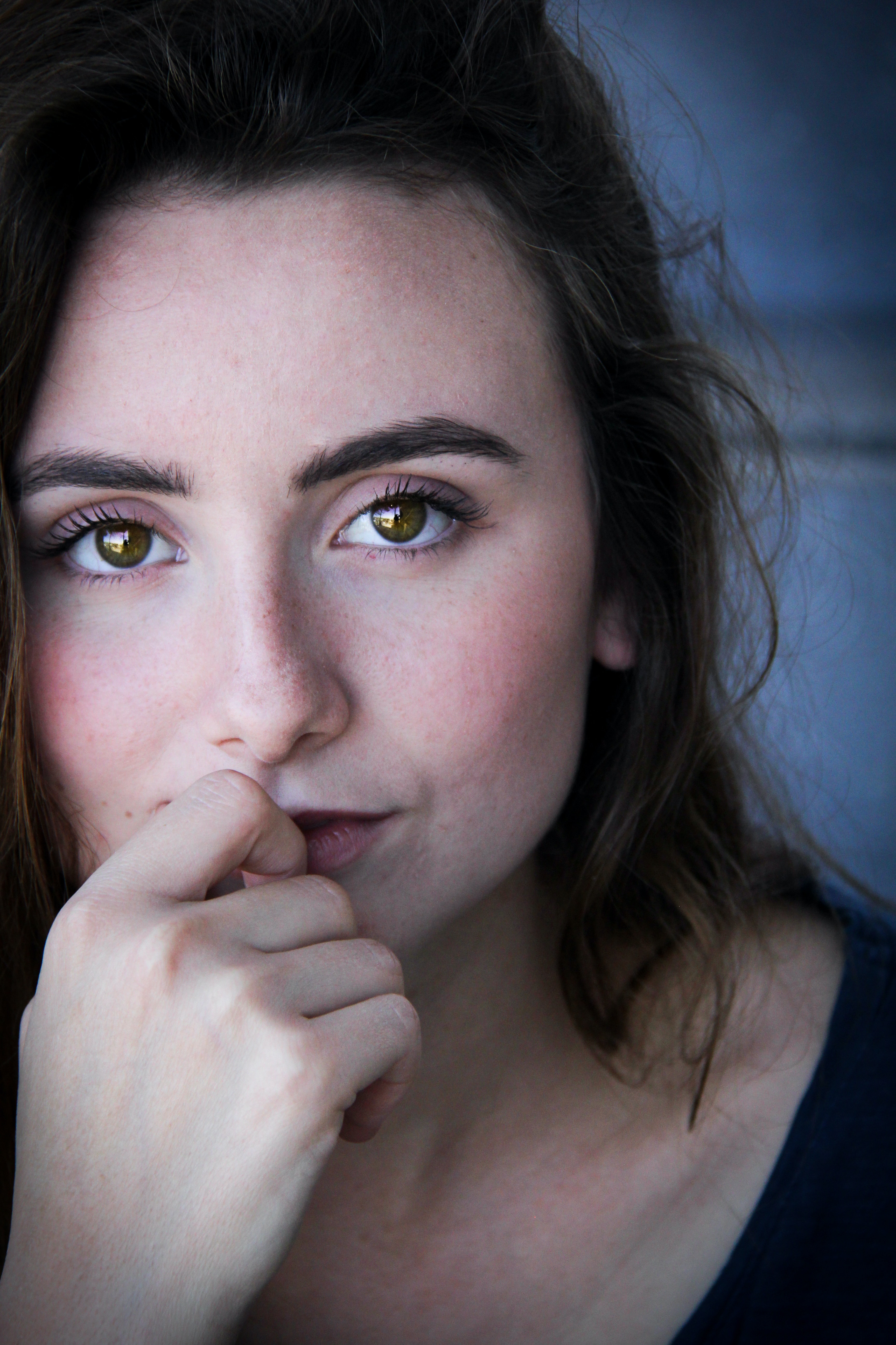 Girl hand on mouth looking forward