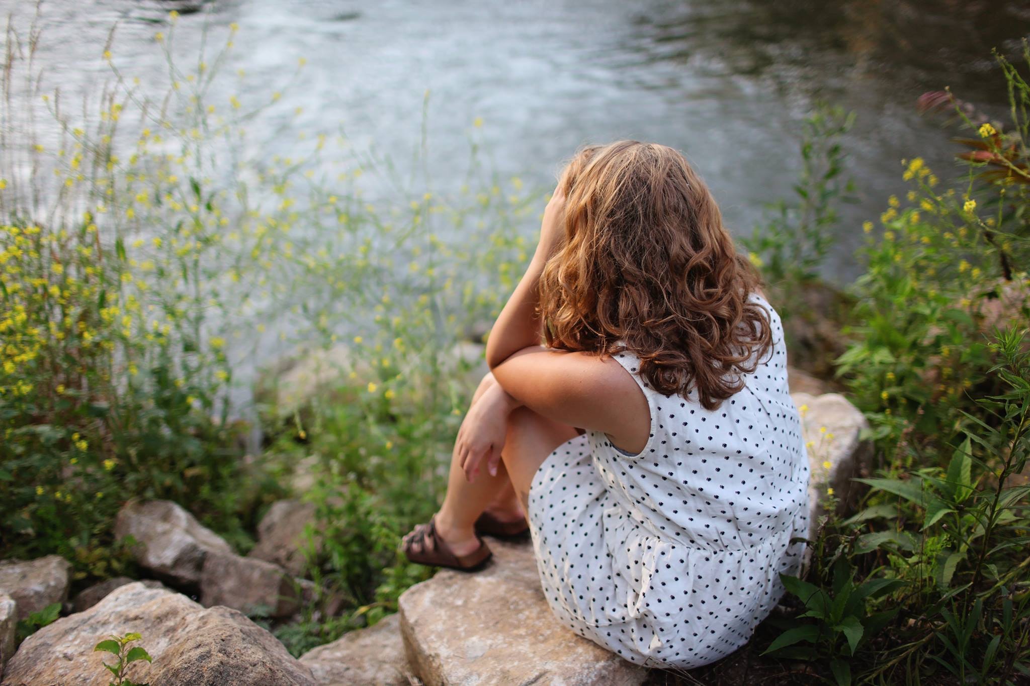 Girl near water back turned
