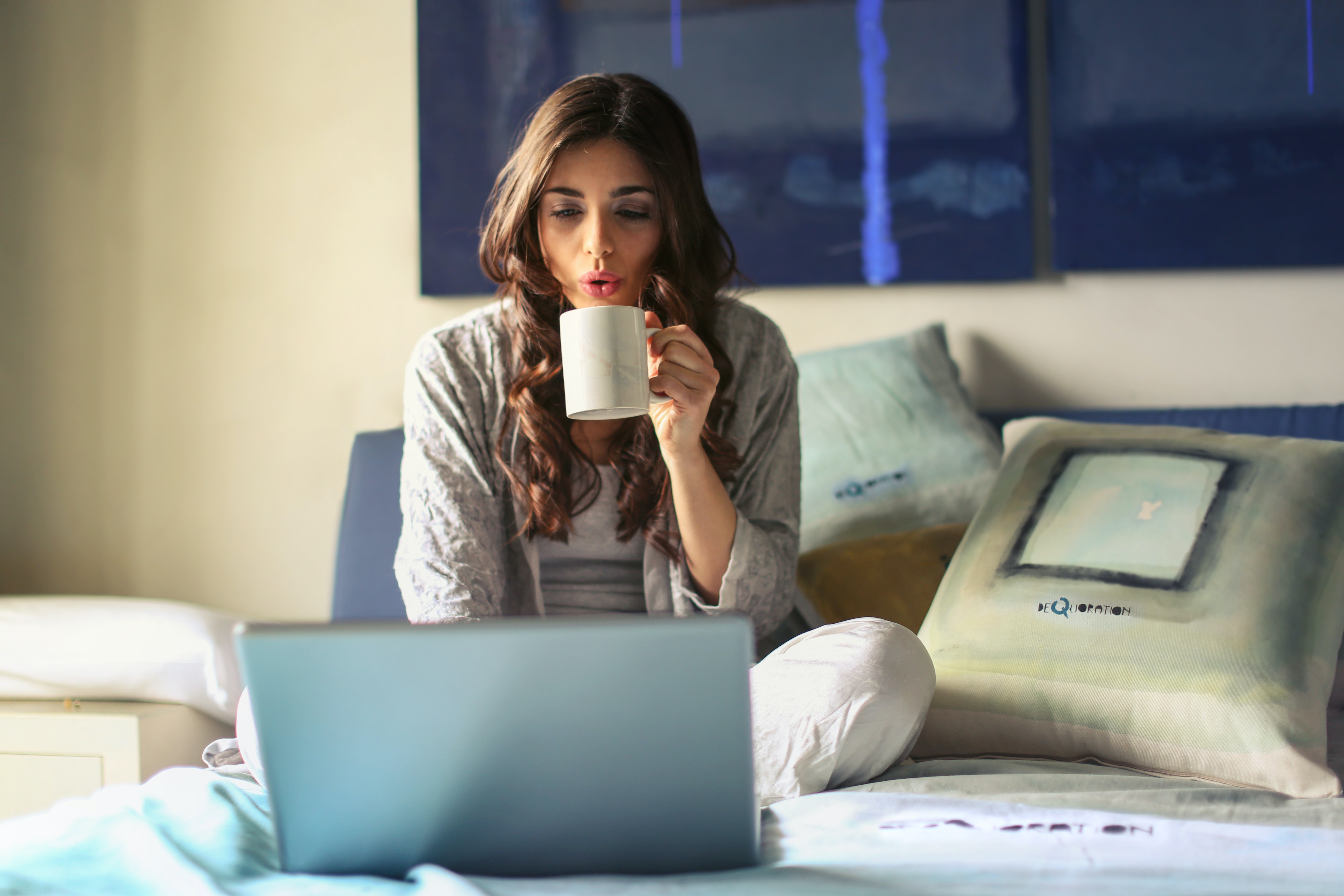girl drinking coffee on computer